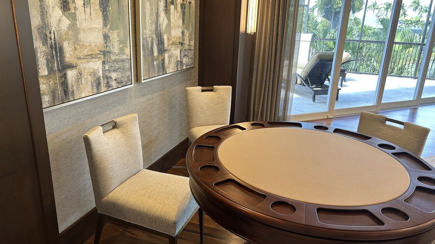 Upholstered dining chairs set neatly around a table in an elegant living space